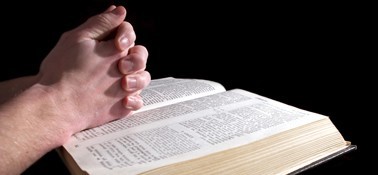 Clasped Hands over Bible Clasped Hands over Bible